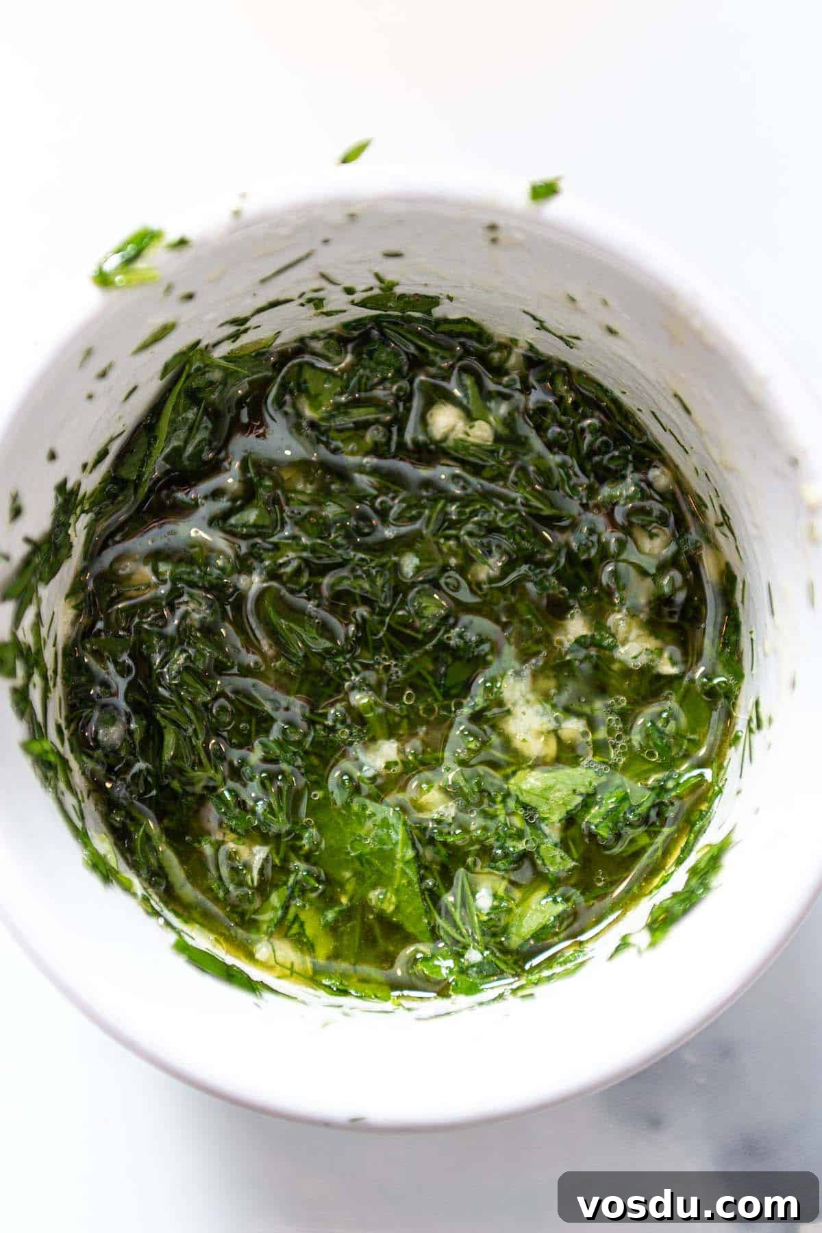 Steamed Salmon with Fresh Herbs and Lemon: Quick Flavorful Recipe 4 A white prep bowl with an olive oil and herb mix.