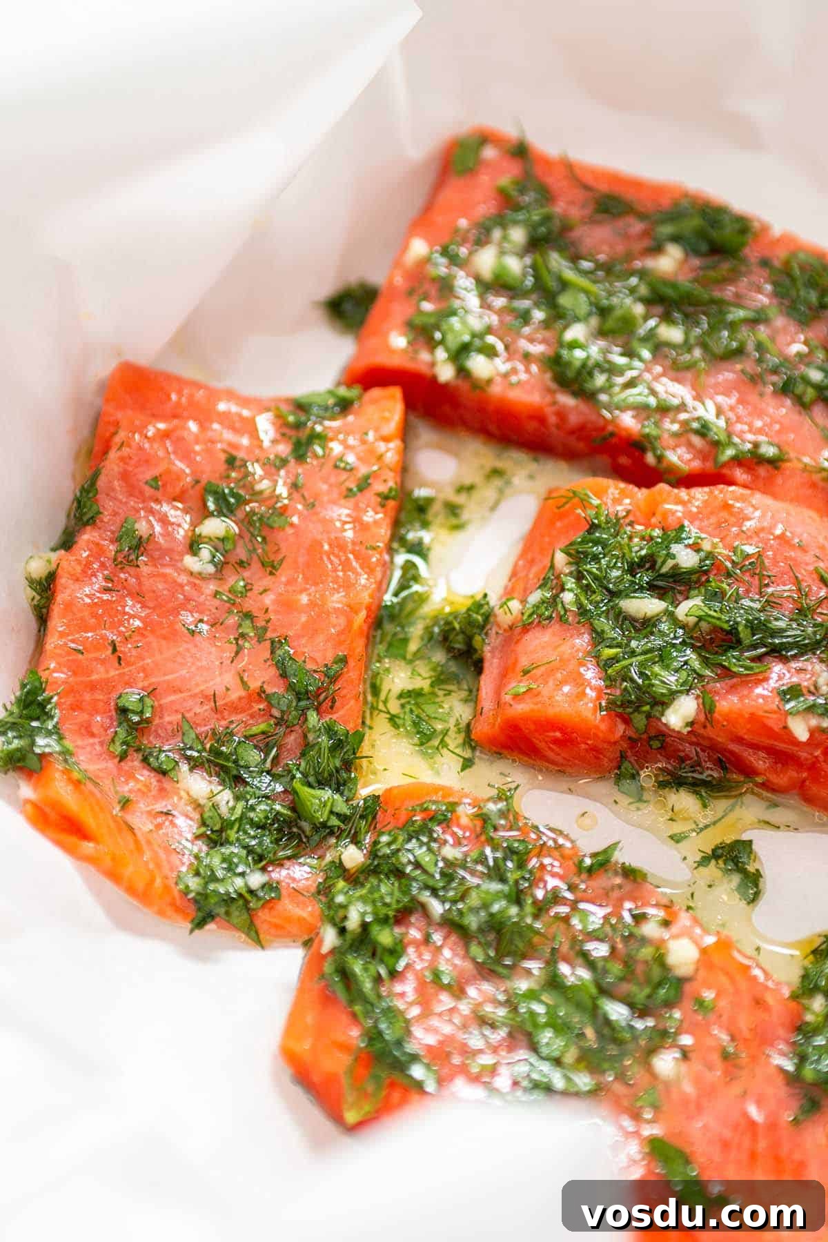 Steamed Salmon with Fresh Herbs and Lemon: Quick Flavorful Recipe 5 Chunks of salmon with herbs and olive oil.