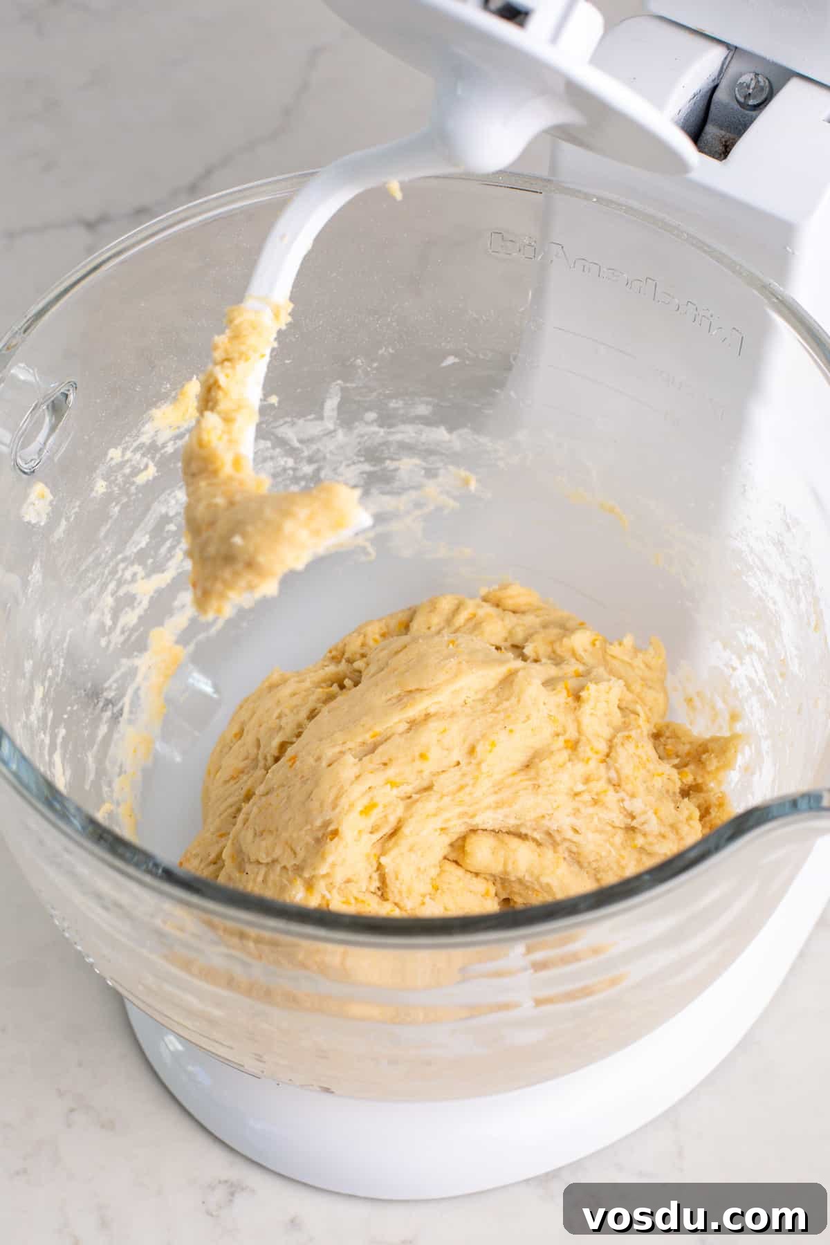 Mixed orange roll dough, ready to be kneaded.