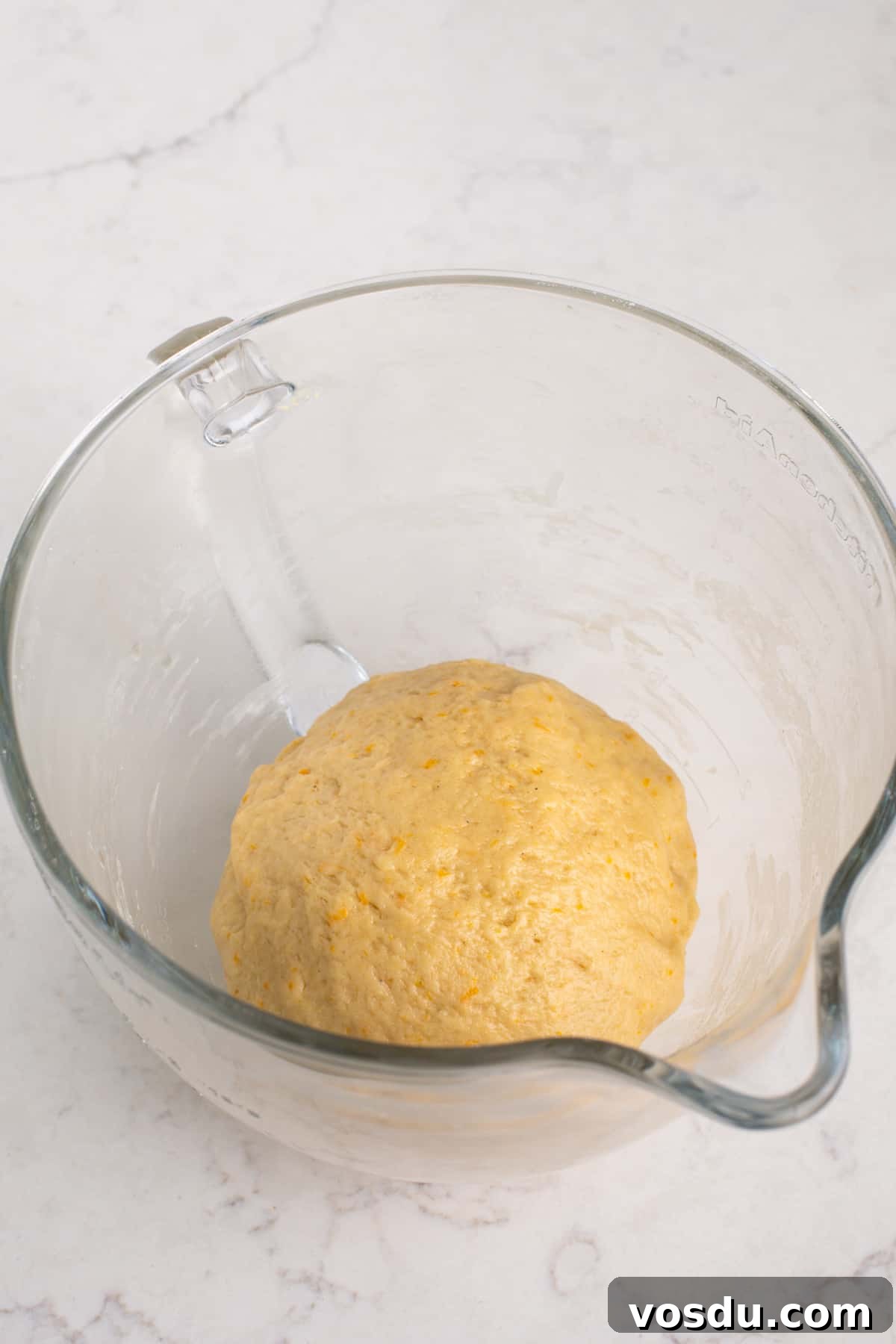 Kneaded orange roll dough, ready to rise.