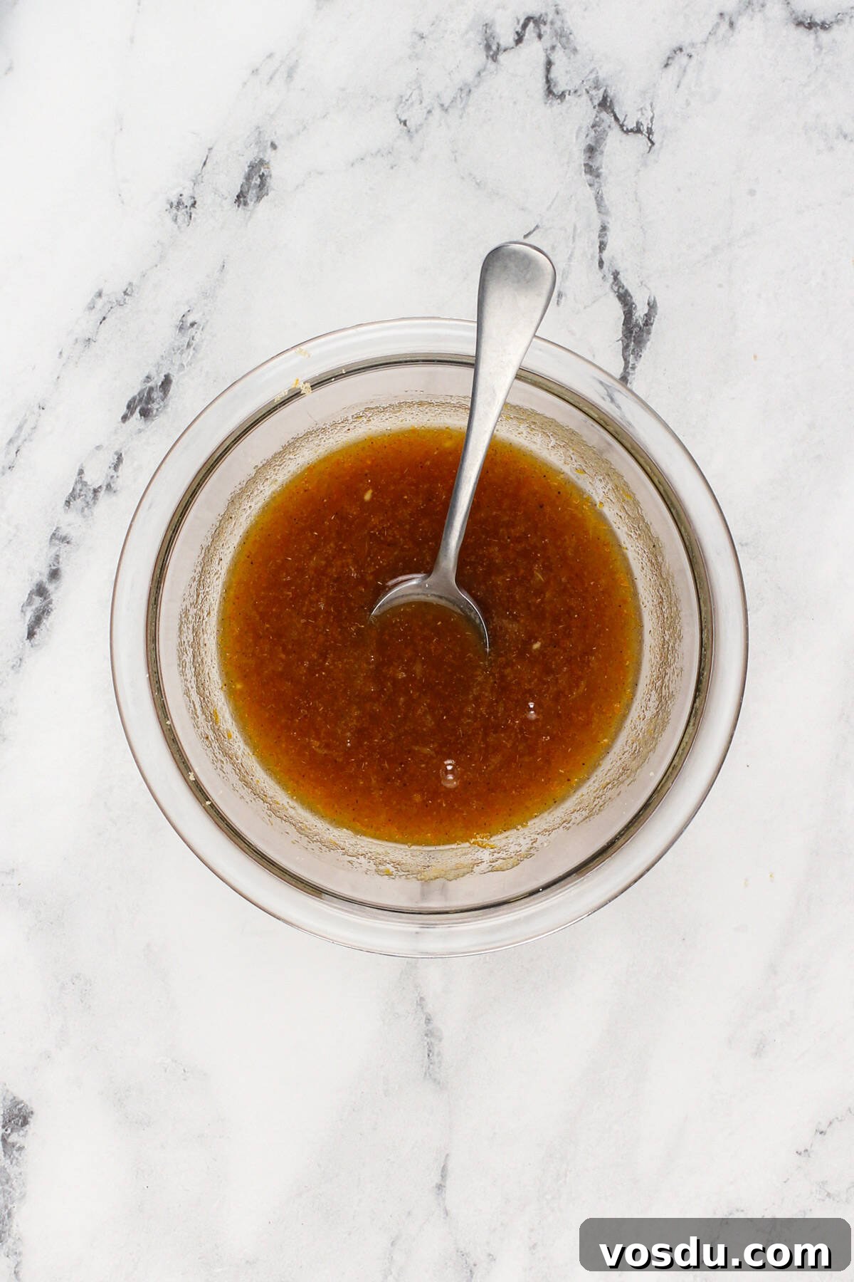 Sticky orange filling in a glass mixing bowl.