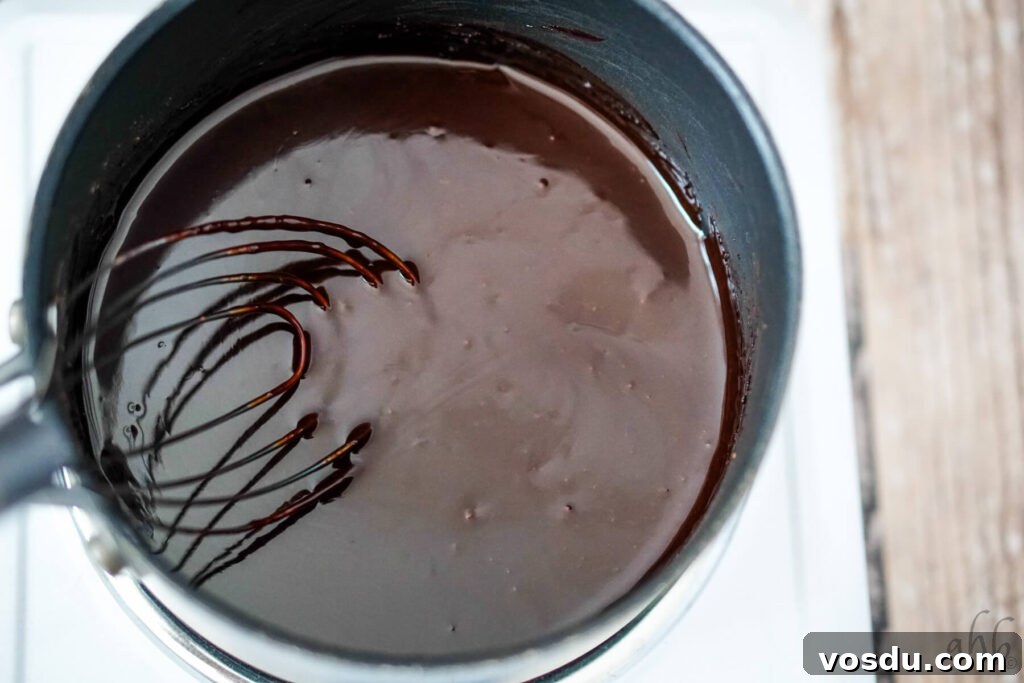 Velvety Orange Hot Chocolate Recipe: Creamy Spiced Cocoa 7 The melted chocolate syrup is whisked with a whisk.