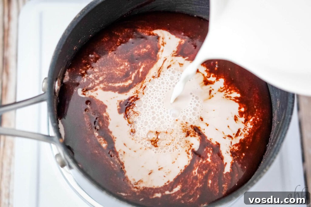 Velvety Orange Hot Chocolate Recipe: Creamy Spiced Cocoa 8 Milk being added to the chocolate syrup base.