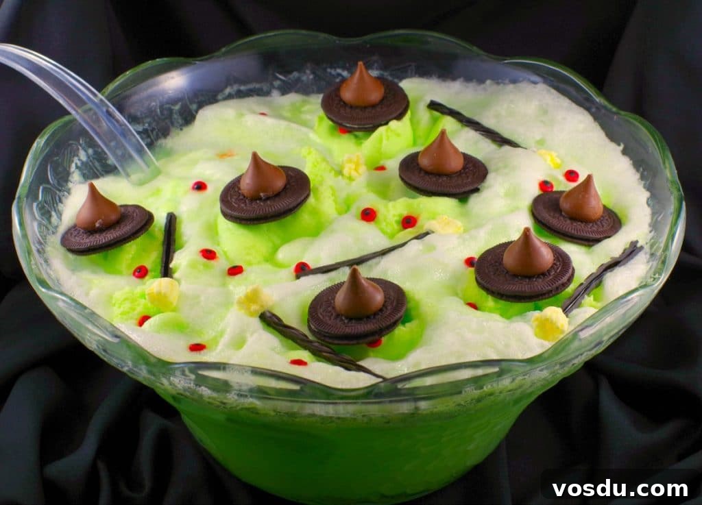 Witches' Brew Halloween Hot Chocolate Recipe for Spooky Nights 4 Melting witch green Halloween punch with chocolate hats, licorice marshmallow brooms and candy eyes