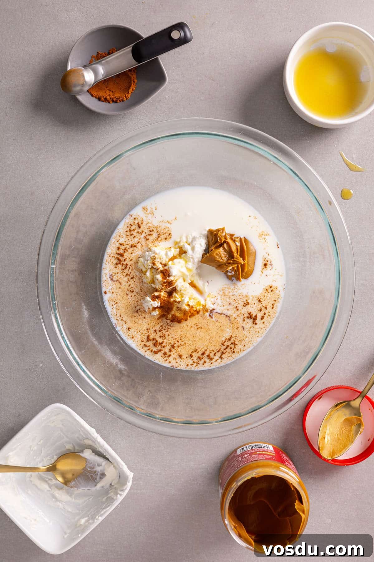Creamy Biscoff Overnight Oats Recipe for Breakfast Delight 4 A bowl with yogurt, cookie butter, milk and more for overnight oats.