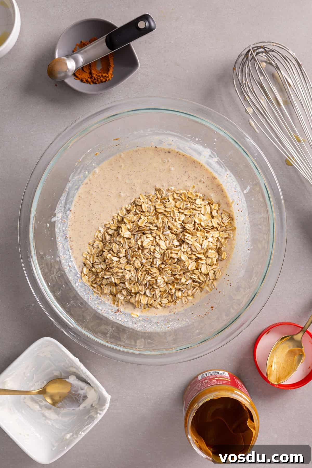 Creamy Biscoff Overnight Oats Recipe for Breakfast Delight 5 Oats added to a bowl with the wet ingredients for cookie butter overnight oats.