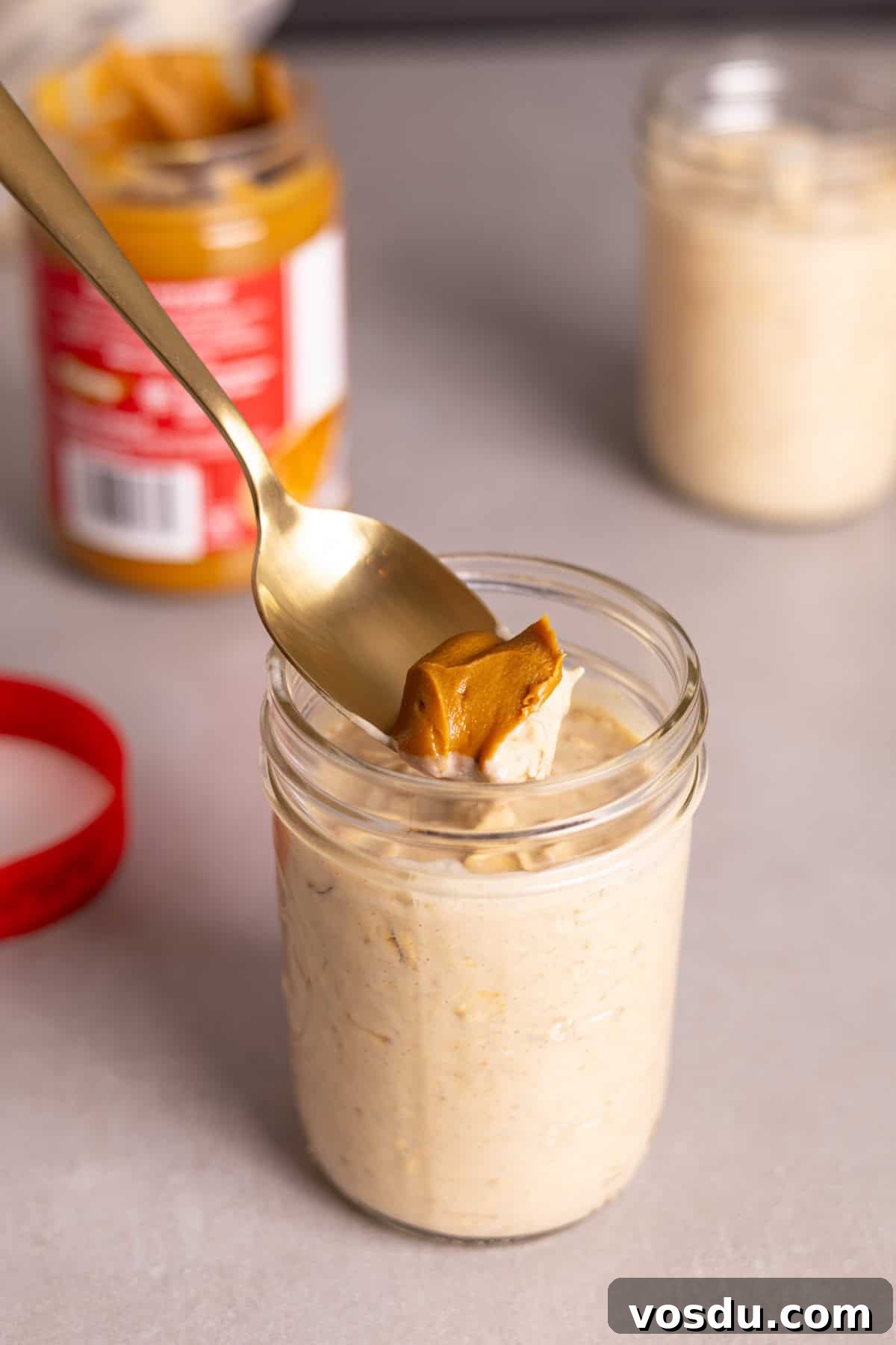 Creamy Biscoff Overnight Oats Recipe for Breakfast Delight 6 A spoon with cookie butter over a portion of Biscoff overnight oats.