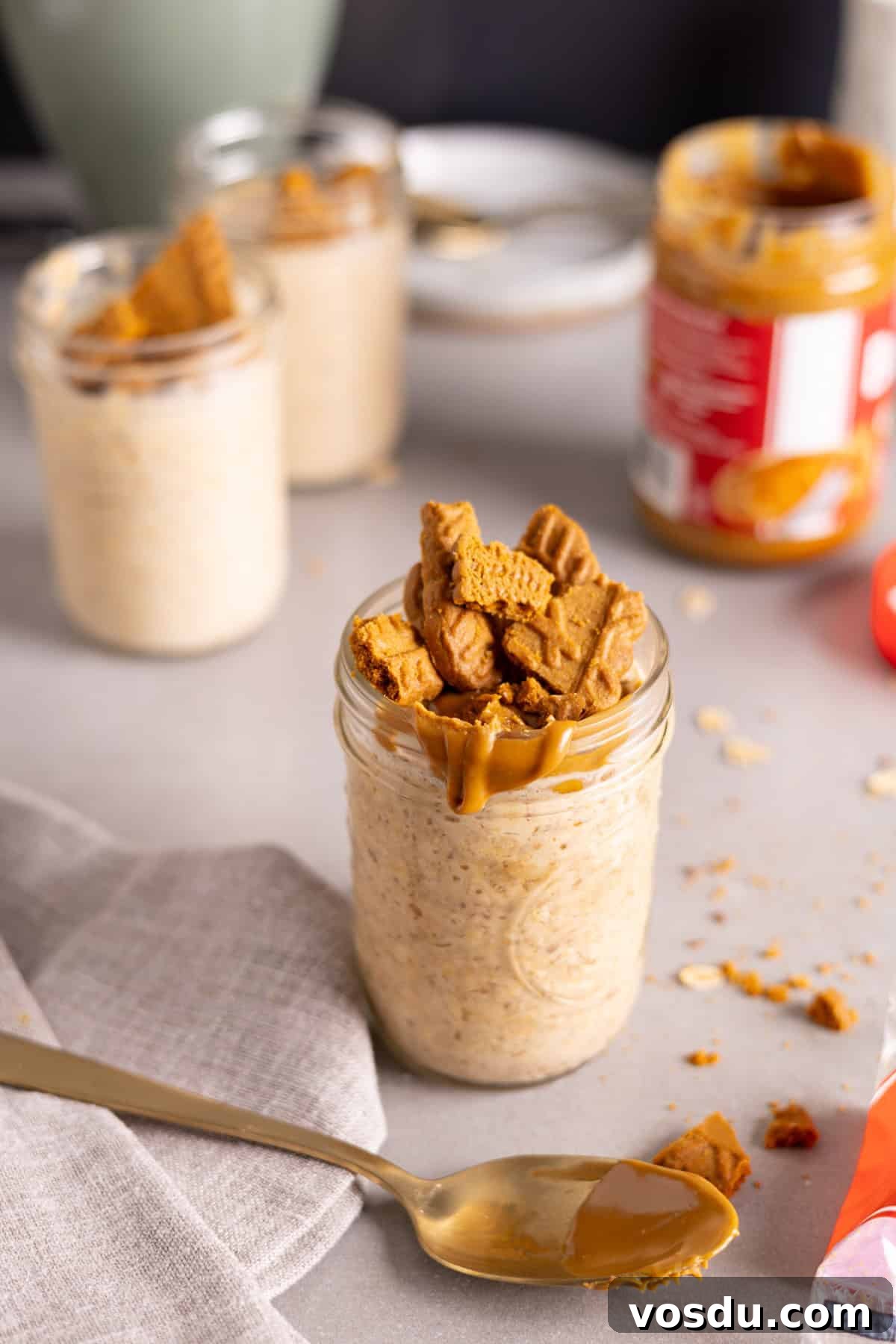 Creamy Biscoff Overnight Oats Recipe for Breakfast Delight 7 Several mason jars with biscoff overnight oats on a gray table.
