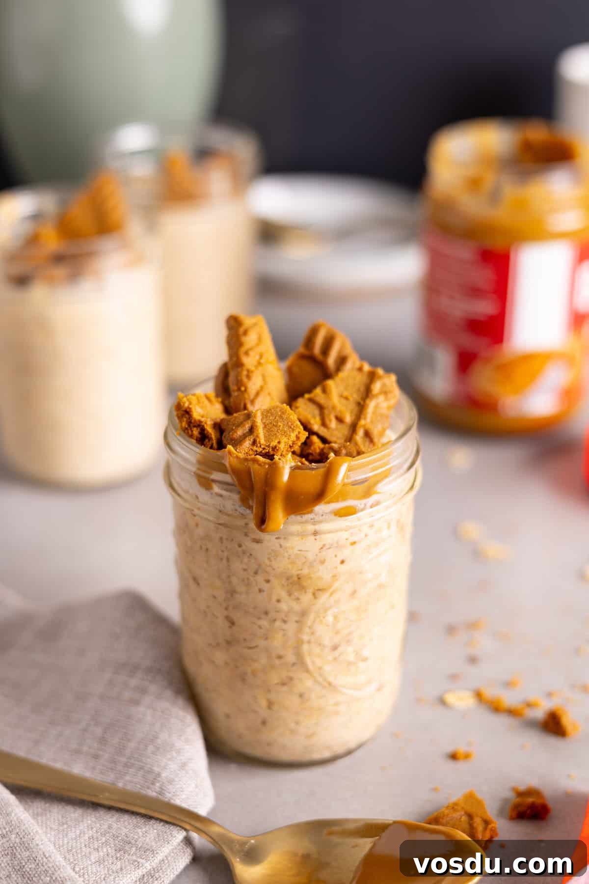 Creamy Biscoff Overnight Oats Recipe for Breakfast Delight 9 Several mason jars with biscoff overnight oats on a gray table.