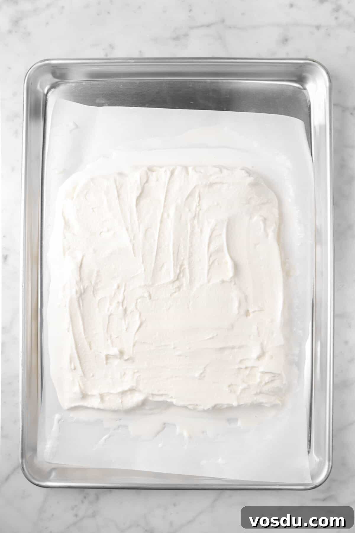 Mickey Mouse Ice Cream Bars: Where to Buy & Nutrition Facts 5 melting vanilla ice cream spread out on a sheet pan