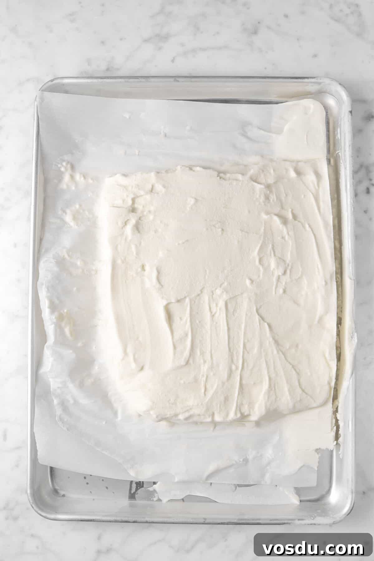 Mickey Mouse Ice Cream Bars: Where to Buy & Nutrition Facts 7 vanilla ice cream frozen and spread out on a sheet pan