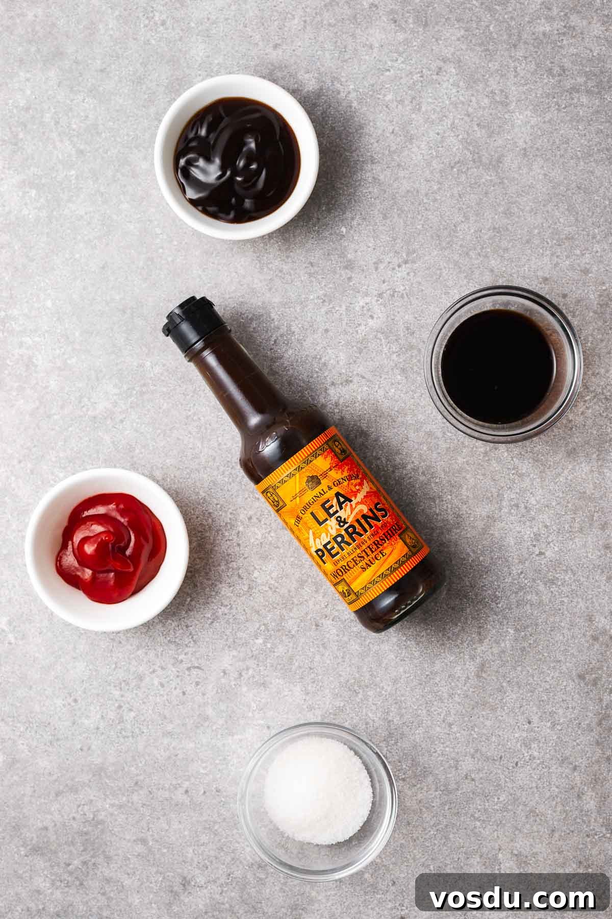 Homemade Yakisoba Sauce: Authentic Japanese Noodle Sauce Recipe 3 Ingredients for yakisoba sauce in small bowls including oyster sauce, soy sauce, tomato ketchup, and sugar. With a bottle of Lea and Perrins Worcestershire sauce.