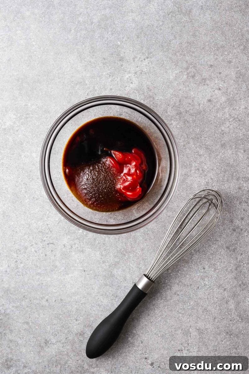 Homemade Yakisoba Sauce: Authentic Japanese Noodle Sauce Recipe 5 Tomato ketchup, soy sauce, sugar and oyster sauce in a glass bowl.
