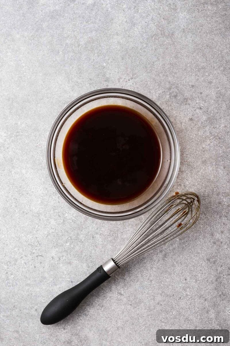 Homemade Yakisoba Sauce: Authentic Japanese Noodle Sauce Recipe 7 Homemade yakisoba noodle sauce in a bowl next to a wire whisk.