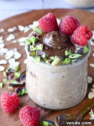 Close-up of Nutella overnight oats with raspberries and pistachios.