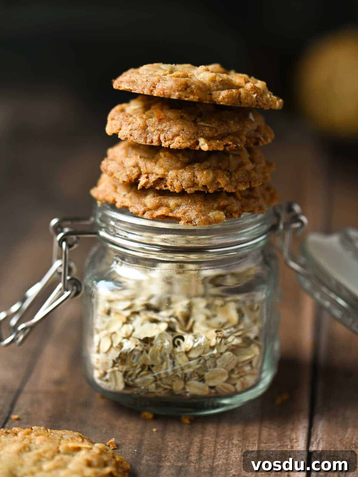 Chewy Coconut Oatmeal Cookies with Toasted Coconut 3 Cookies stacked on a jar of oatmeal.