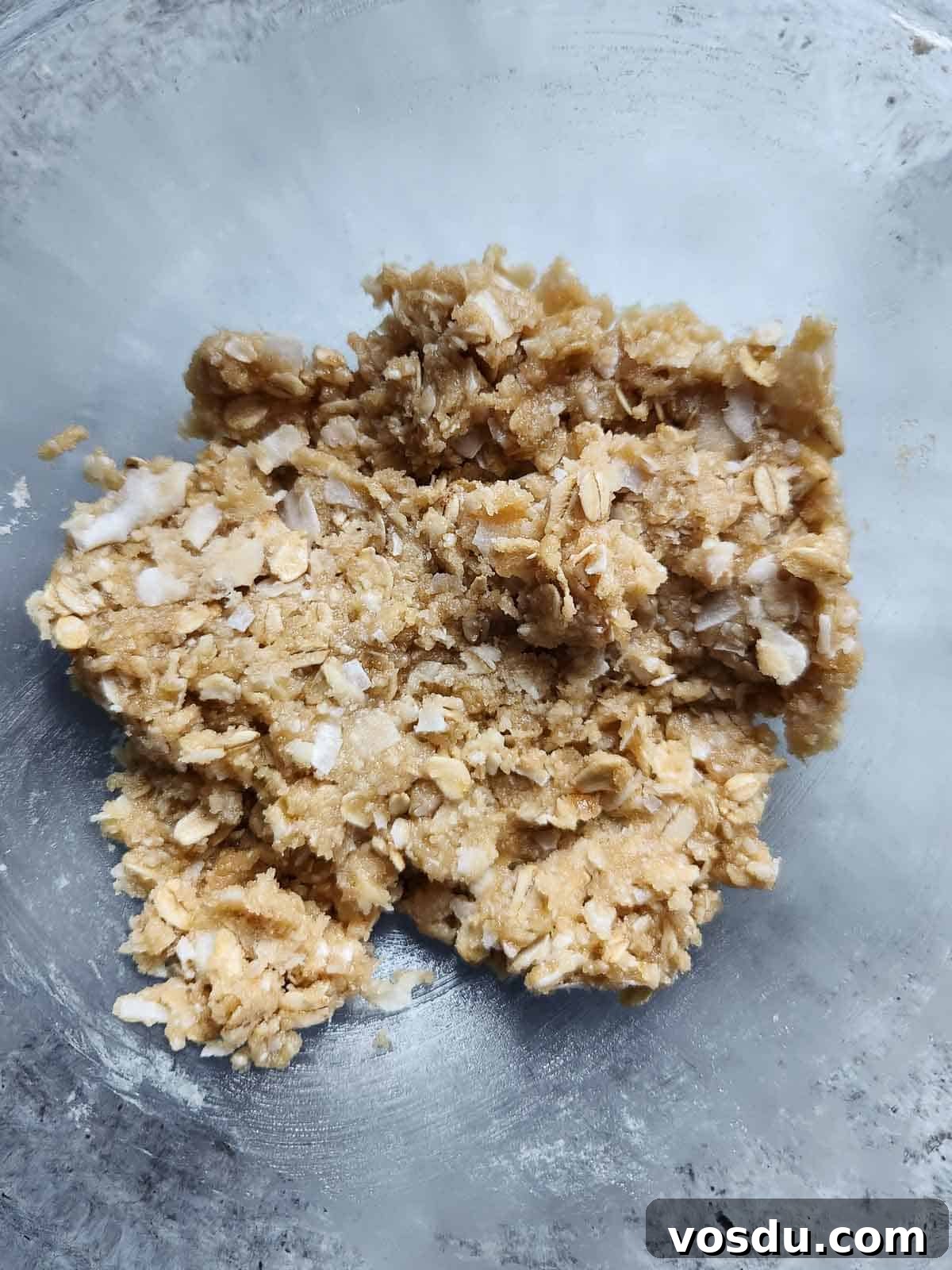 Chewy Coconut Oatmeal Cookies with Toasted Coconut 5 Batter for coconut oatmeal cookies in a clear bowl.