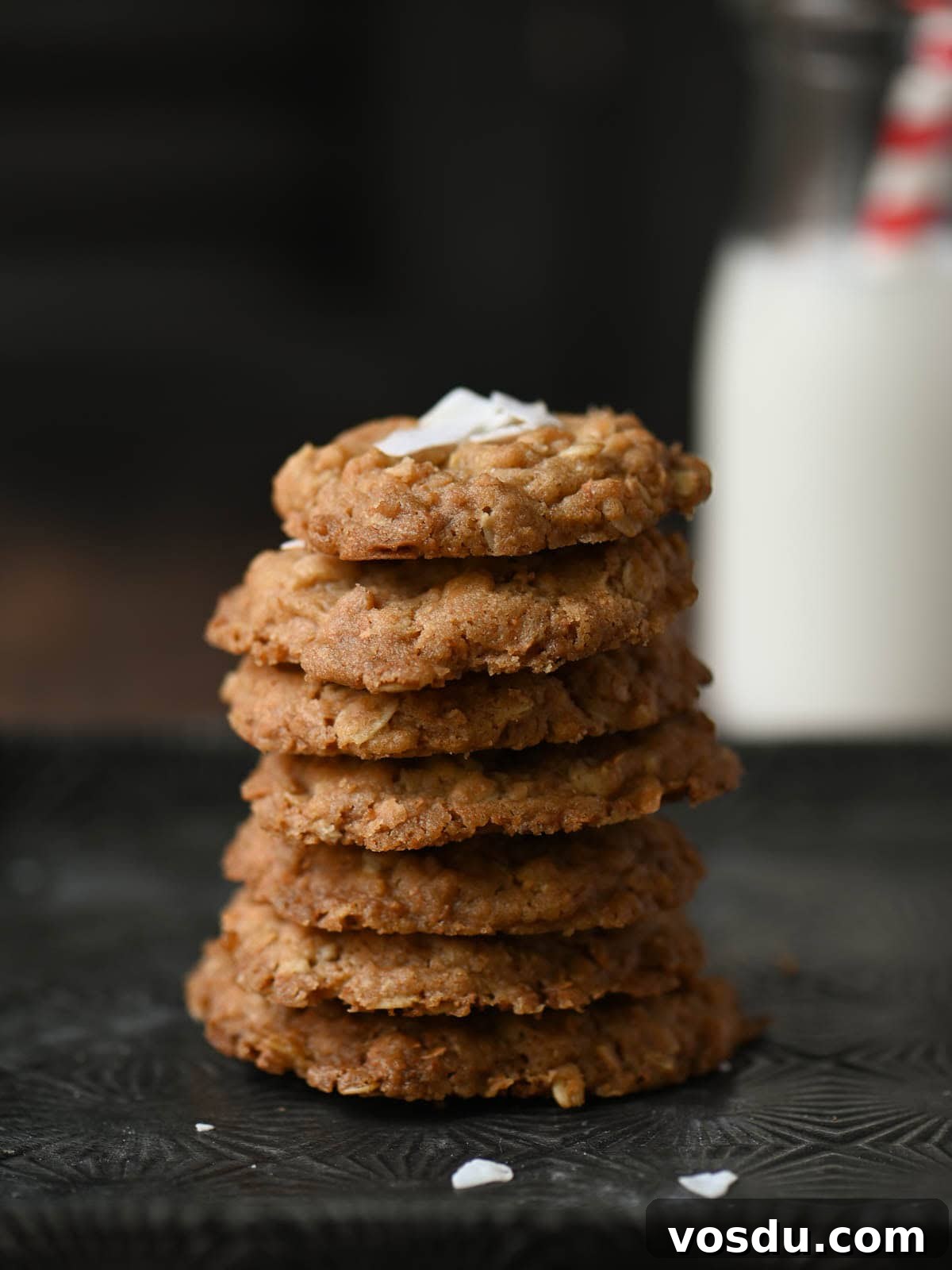Chewy Coconut Oatmeal Cookies with Toasted Coconut 8 A stack of oatmeal cookies on a tin tray.