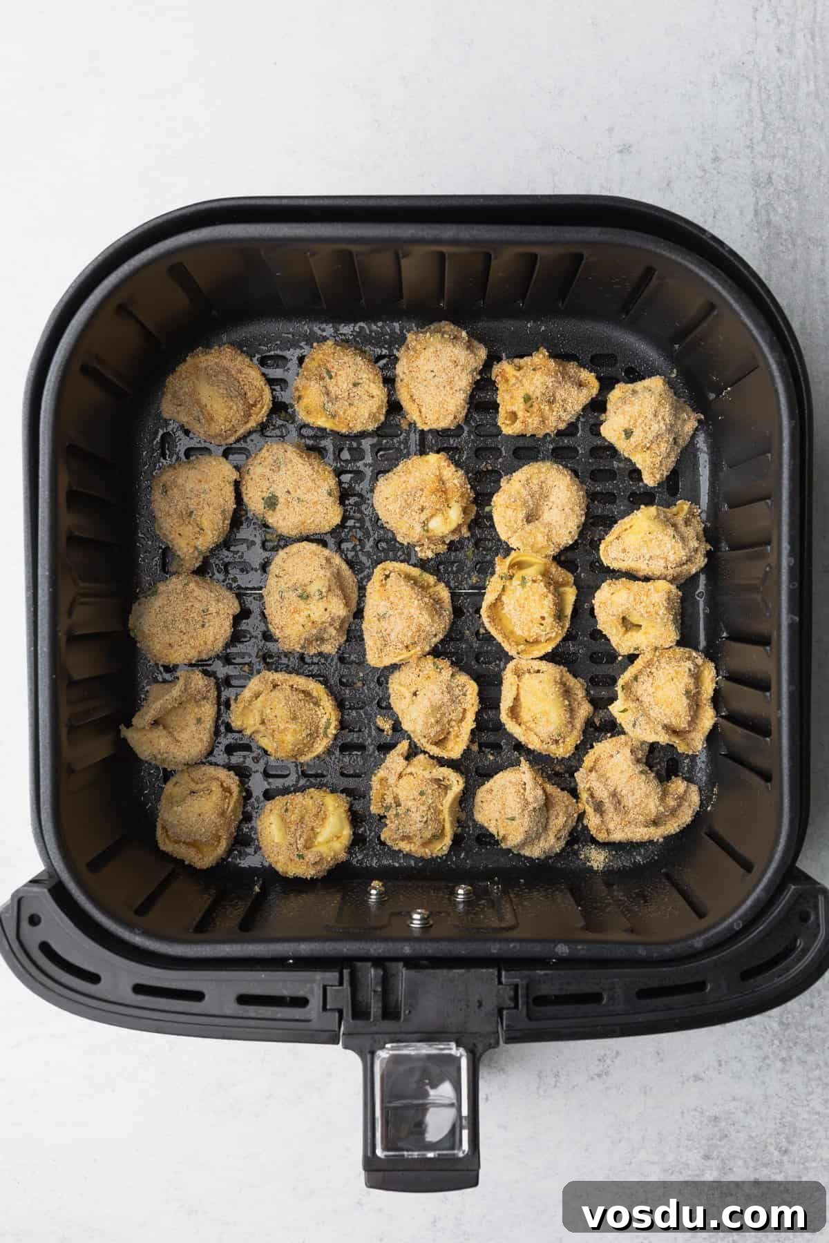 Crispy Air-Fried Tortellini with Garlic Parmesan Dipping Sauce 8 tortellini in the air fryer basket in a single layer