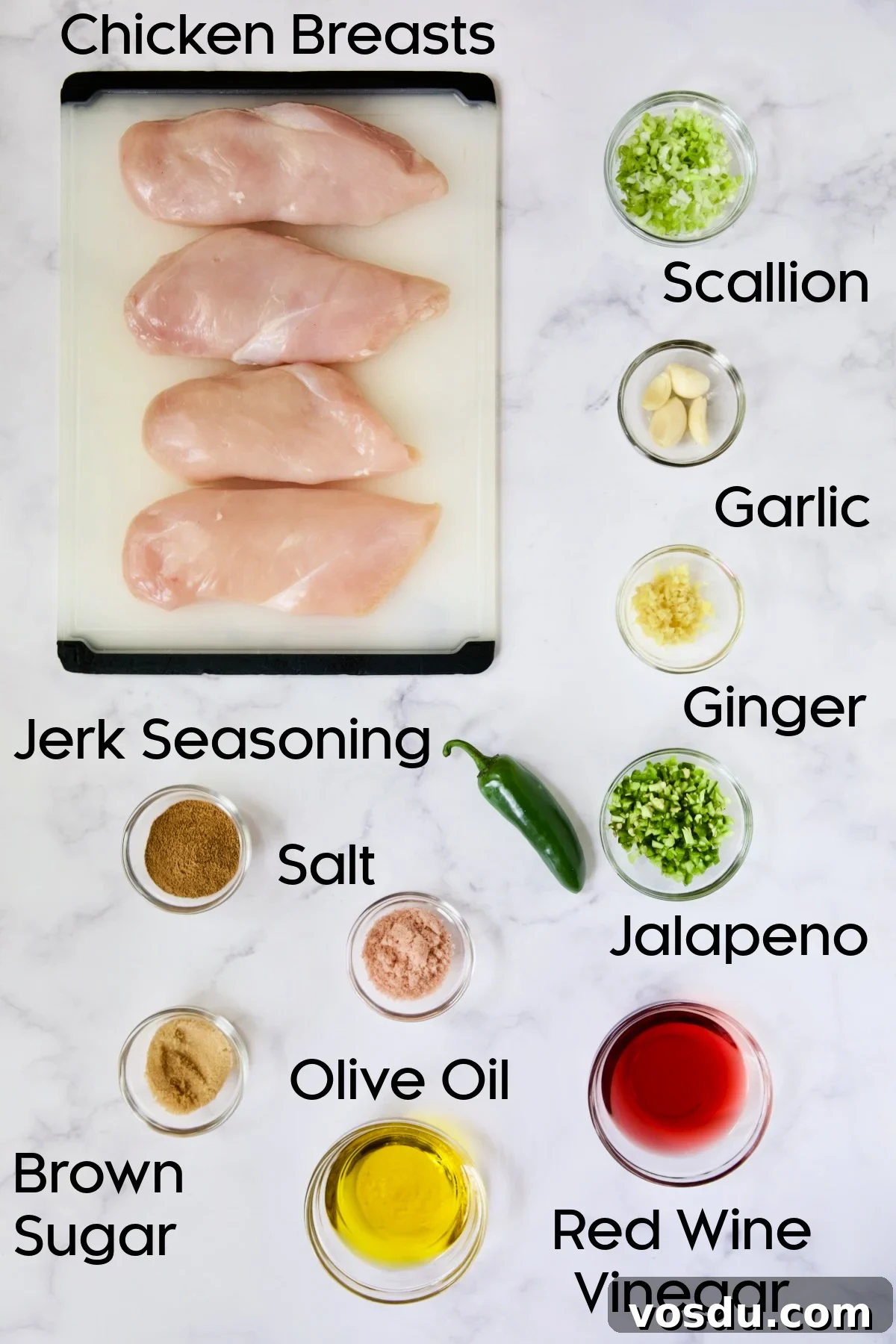 Caribbean Chicken with Black Bean and Mango Salsa Recipe 4 Ingredients for Caribbean Jerk Chicken on glass bowls and four uncooked chicken breasts on white cutting board.