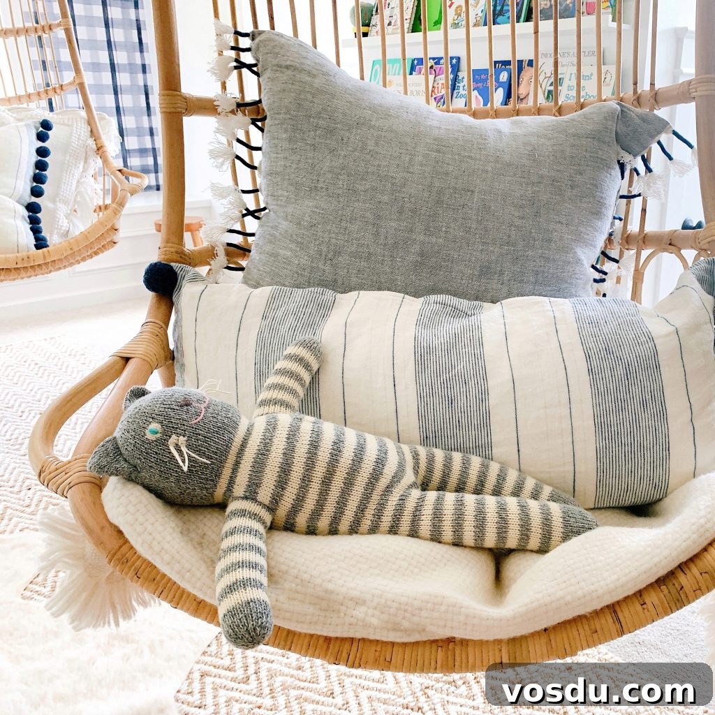 9 Stylish Hanging Rattan Chairs You’ll Love 7 Serena & lily hanging rattan chair with a stuffed animal in it