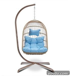 9 Stylish Hanging Rattan Chairs You’ll Love 10 hanging chair on stand with blue cushions