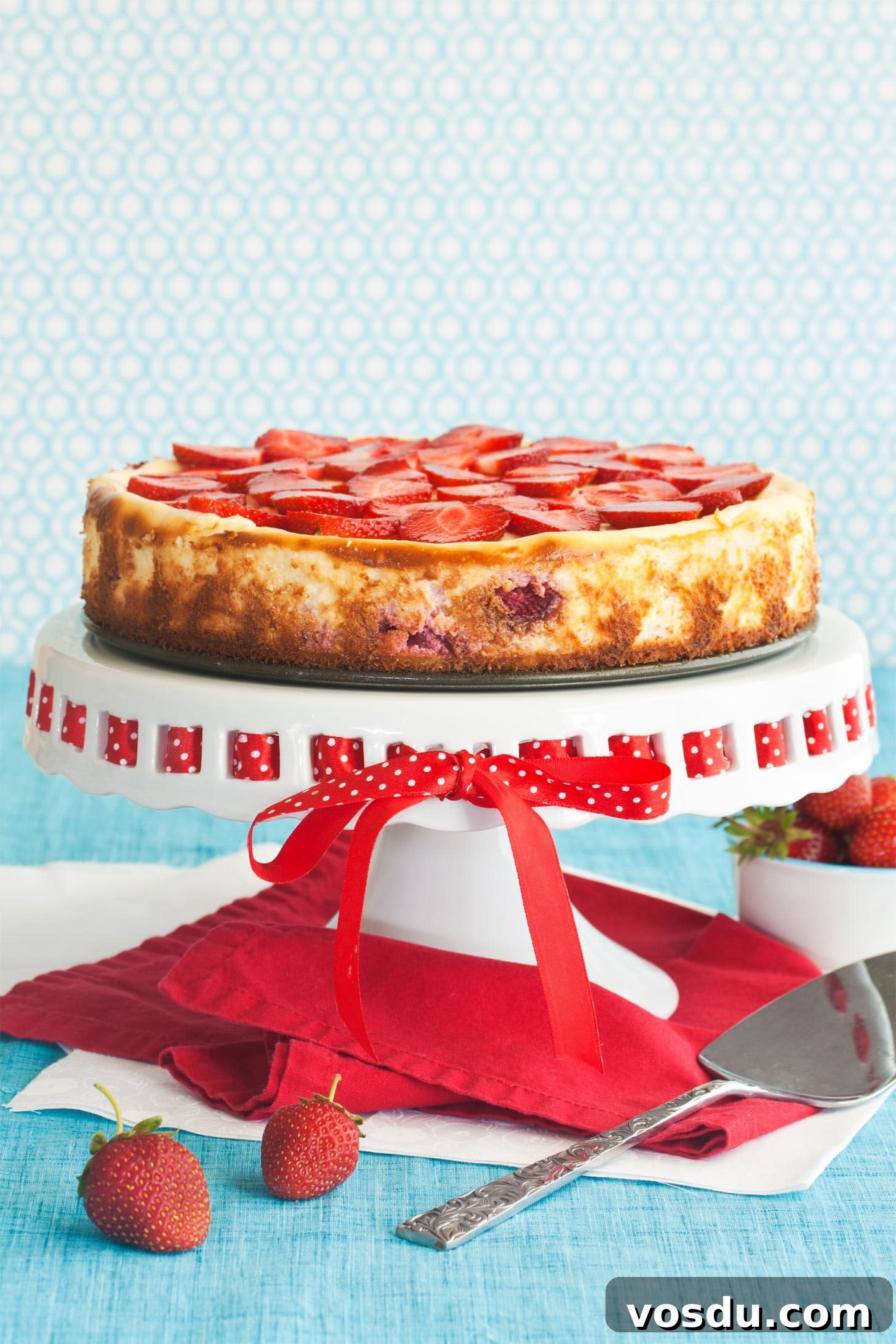 Strawberry Shortcake Cheesecake on top of cake stand