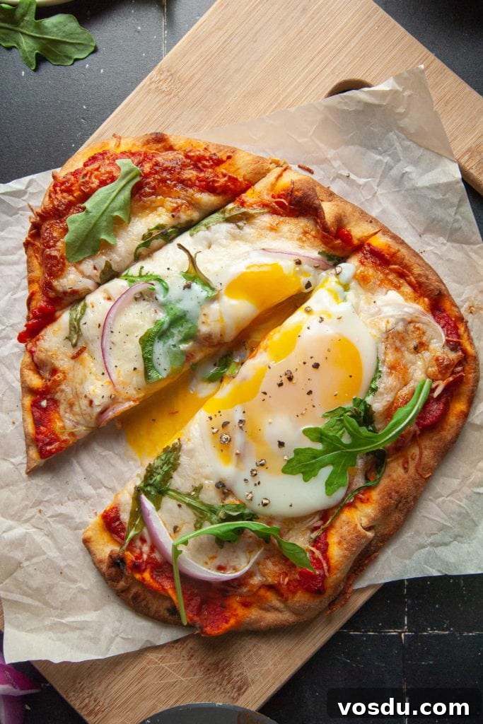 15-Minute Vegetarian Naan Breakfast Pizza Recipe 2 Slicing into Naan Breakfast Pizza with Yolk Oozing