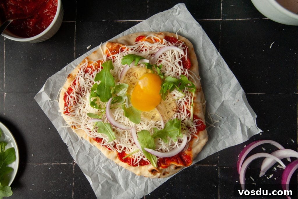 15-Minute Vegetarian Naan Breakfast Pizza Recipe 6 Cracking an Egg onto Naan Pizza