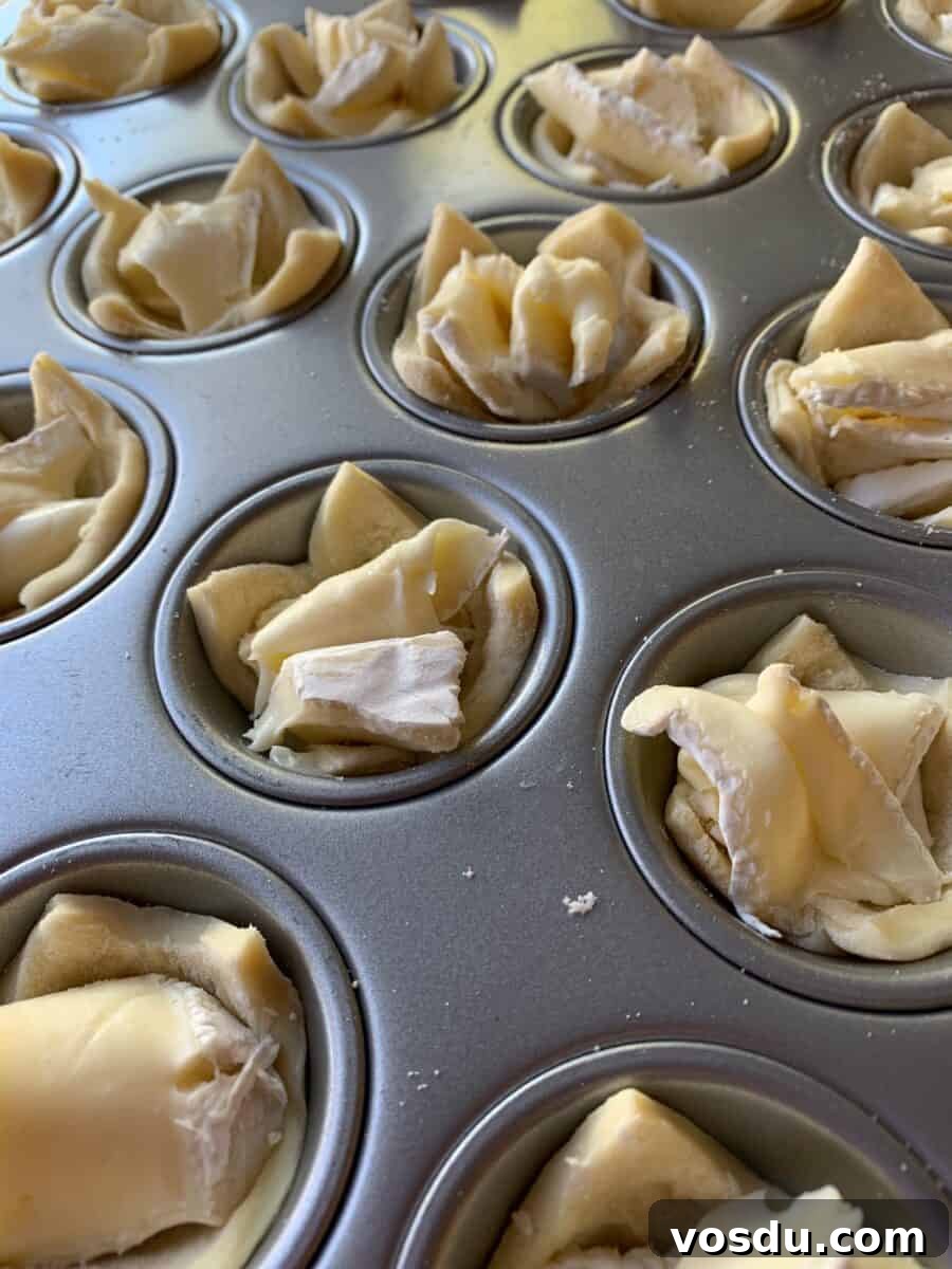 Cranberry Brie Bites: Festive Appetizer with Puff Pastry 5 Brie and pastry dough in a mini muffin pan