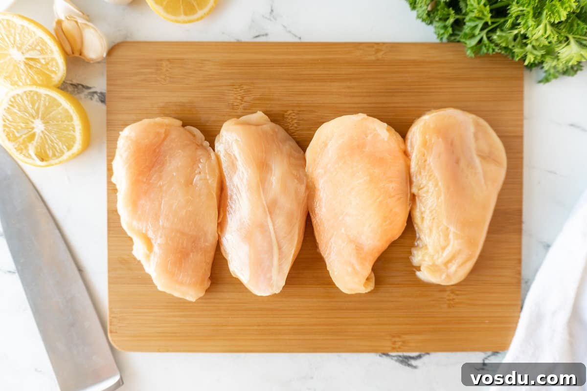 Juicy Smoked Chicken Breast Recipe for Tender, Flavorful Results 5 raw chicken breasts on cutting board