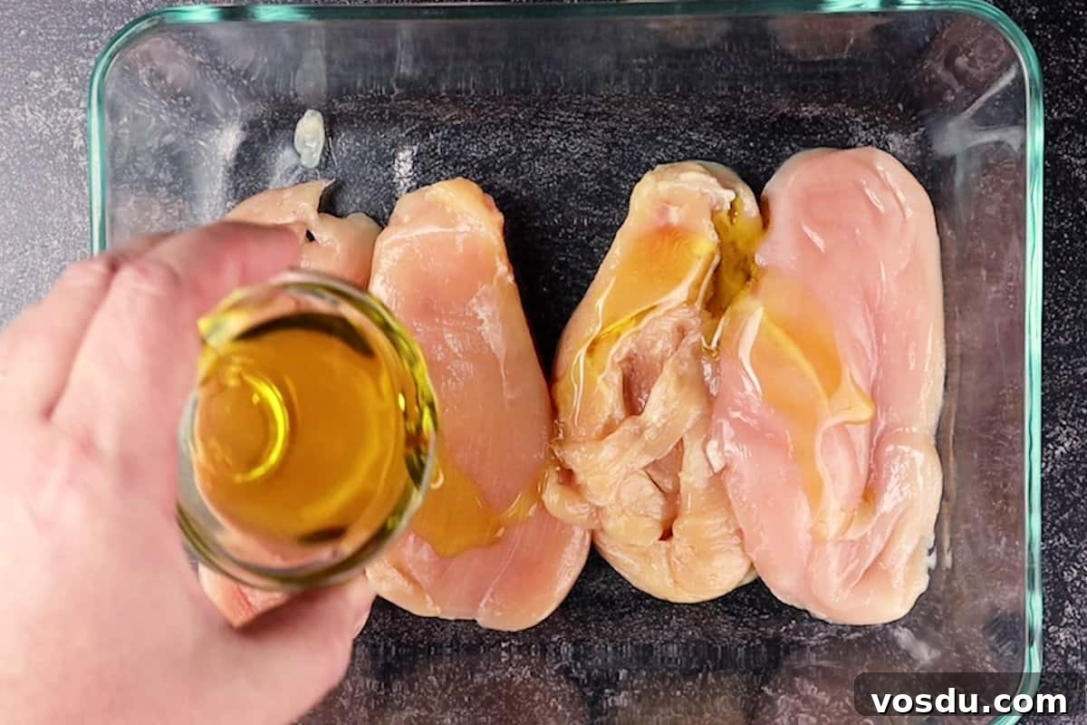 Juicy Smoked Chicken Breast Recipe for Tender, Flavorful Results 10 adding oil to chicken breast