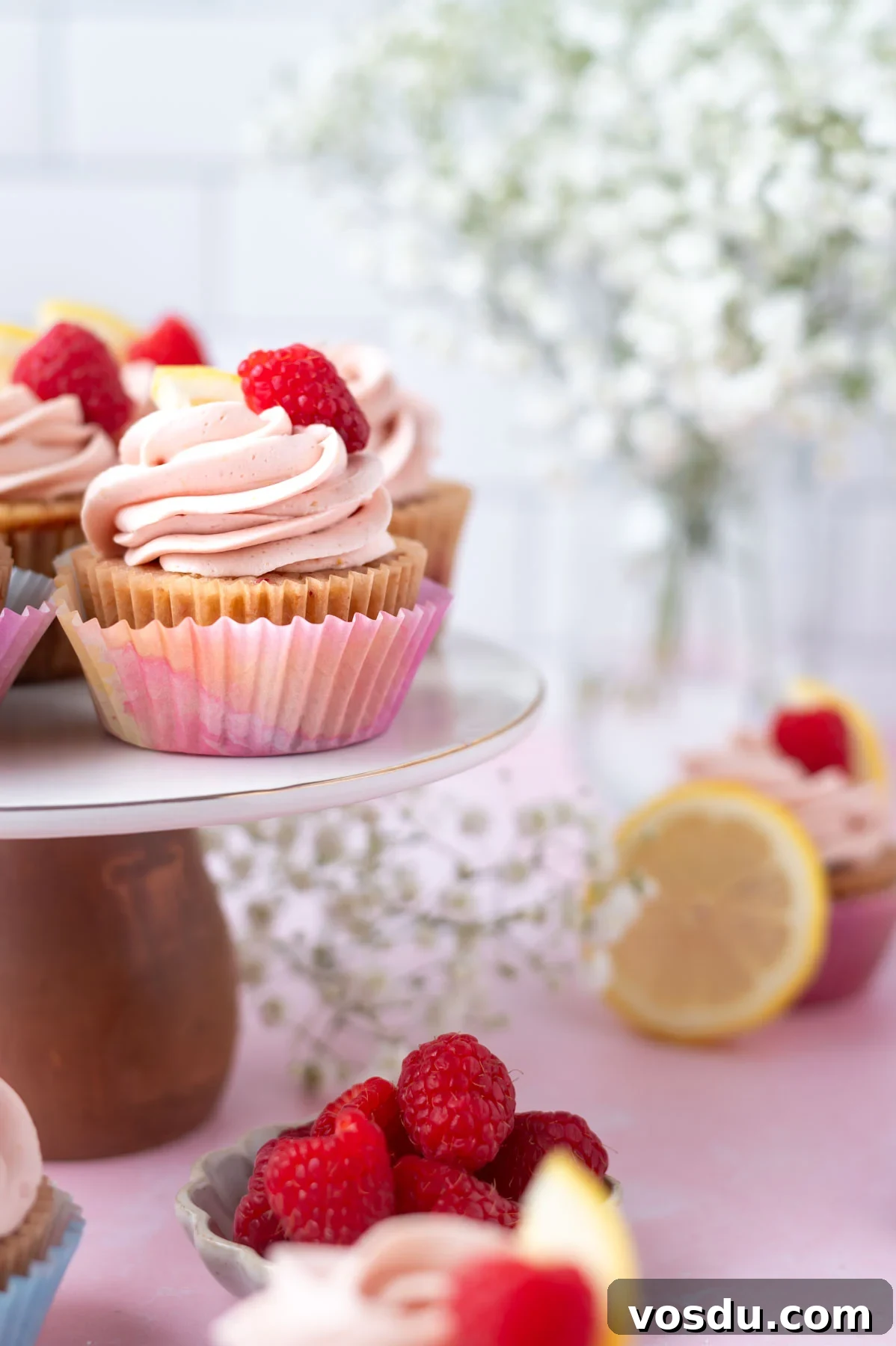 Lemon Raspberry Cupcakes Made from Scratch: Bright Citrus Dessert 11 cupcakes on a cake stand with flowers in the background