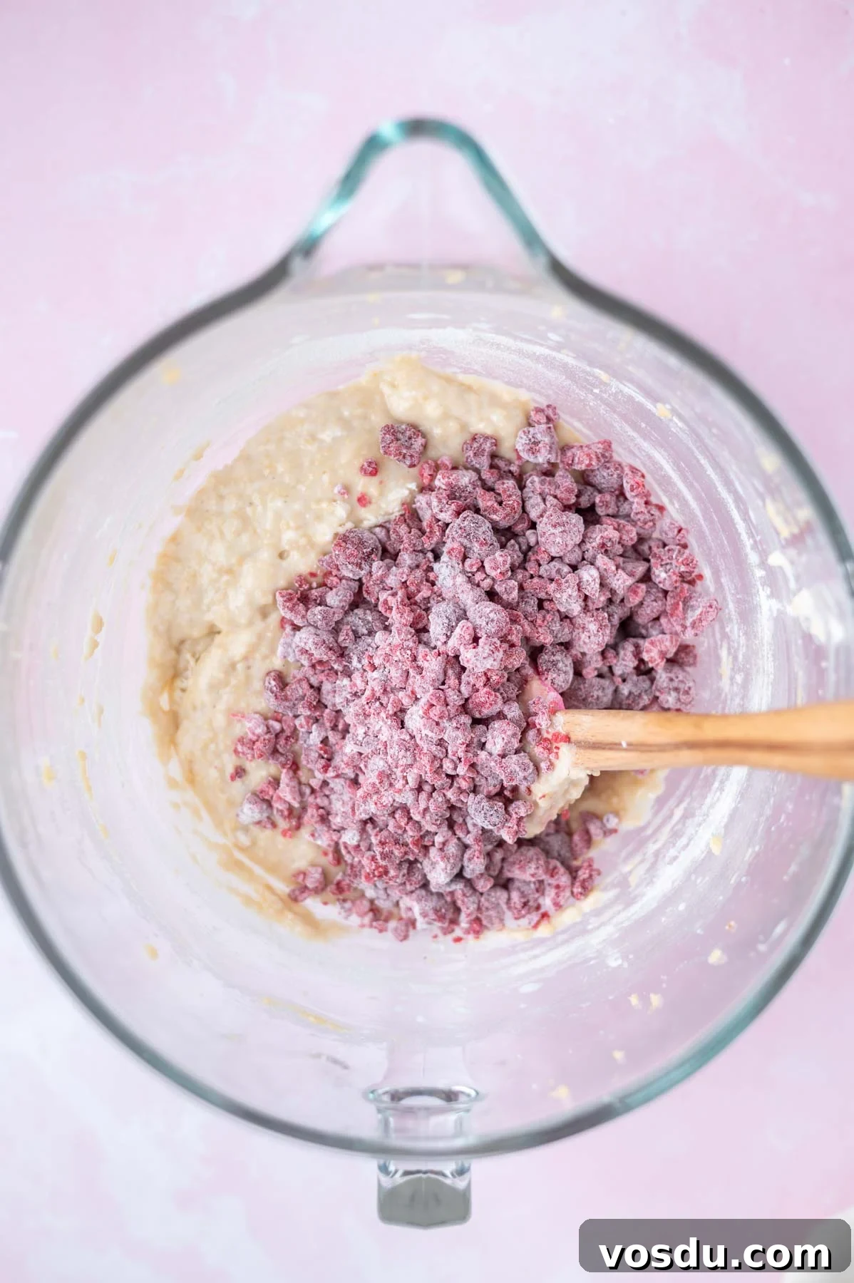 Lemon Raspberry Cupcakes Made from Scratch: Bright Citrus Dessert 7 frozen raspberries tossed with flour on top of lemon cupcake batter in a bowl with a spatula