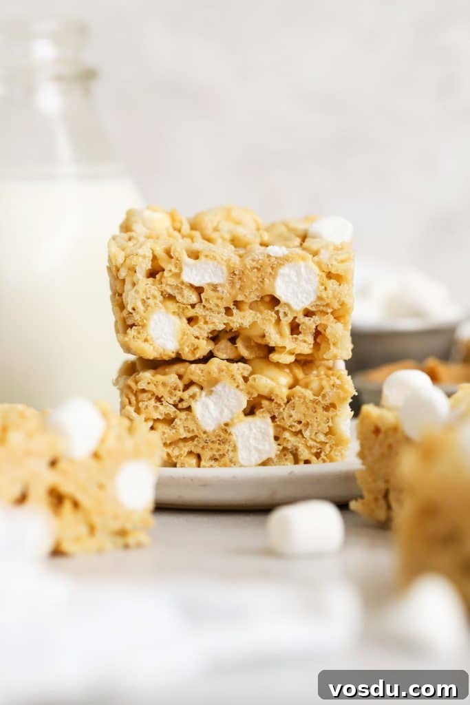 Chocolate Rice Krispie Treats Recipe for Crispy, Chocolatey Squares 11 gluten-free peanut butter rice krispie treats stacked on a white plate