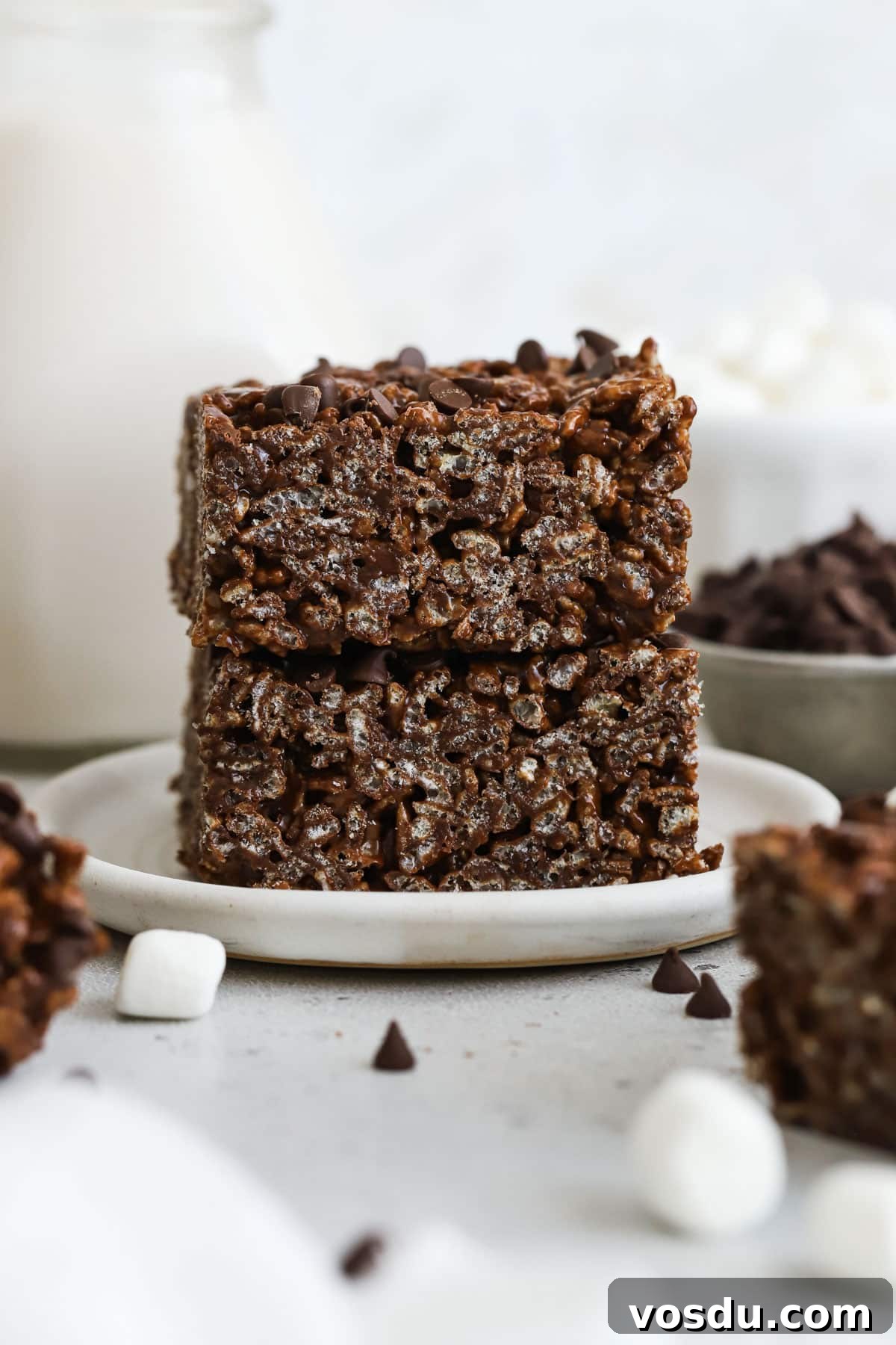 Chocolate Rice Krispie Treats Recipe for Crispy, Chocolatey Squares 7 gluten-free chocolate rice krispies treats stacked on a white dessert plate
