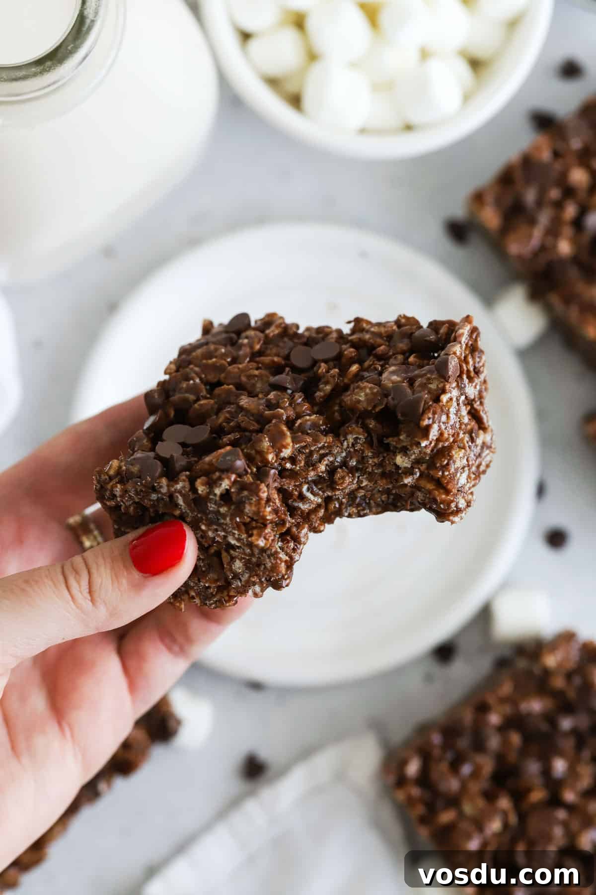 Chocolate Rice Krispie Treats Recipe for Crispy, Chocolatey Squares 8 a gluten-free chocolate rice krispie treat with a bite taken out of it
