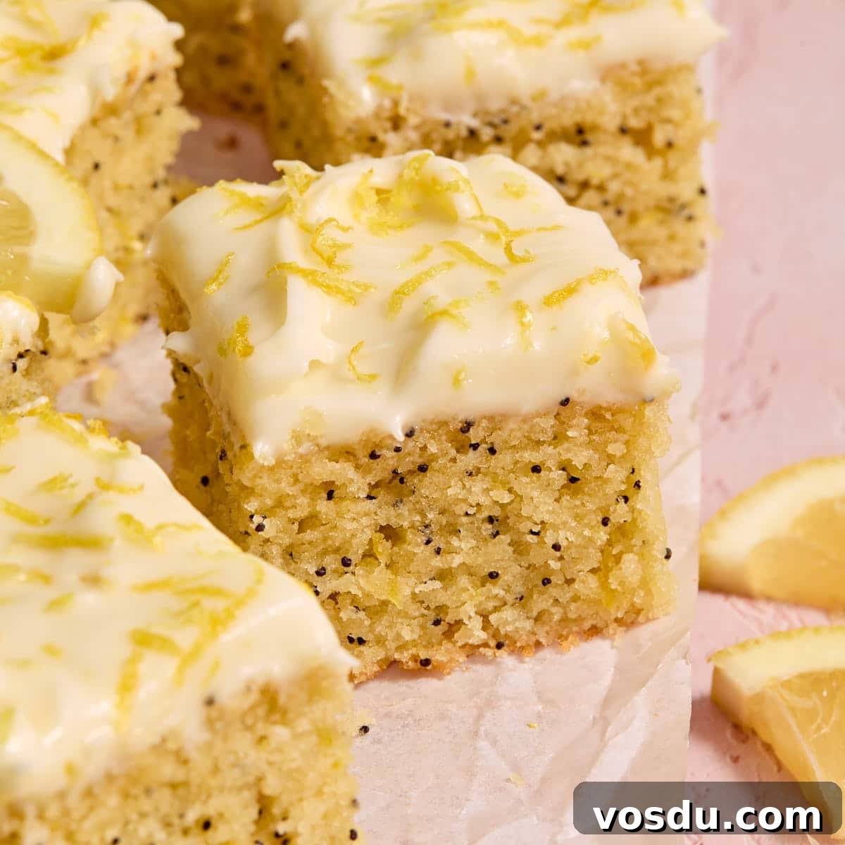 Almond Flour Lemon Poppy Seed Cake Recipe for Moist, Zesty Loaf 19 Pieces of almond flour lemon poppy seed cake arranged on parchment paper.
