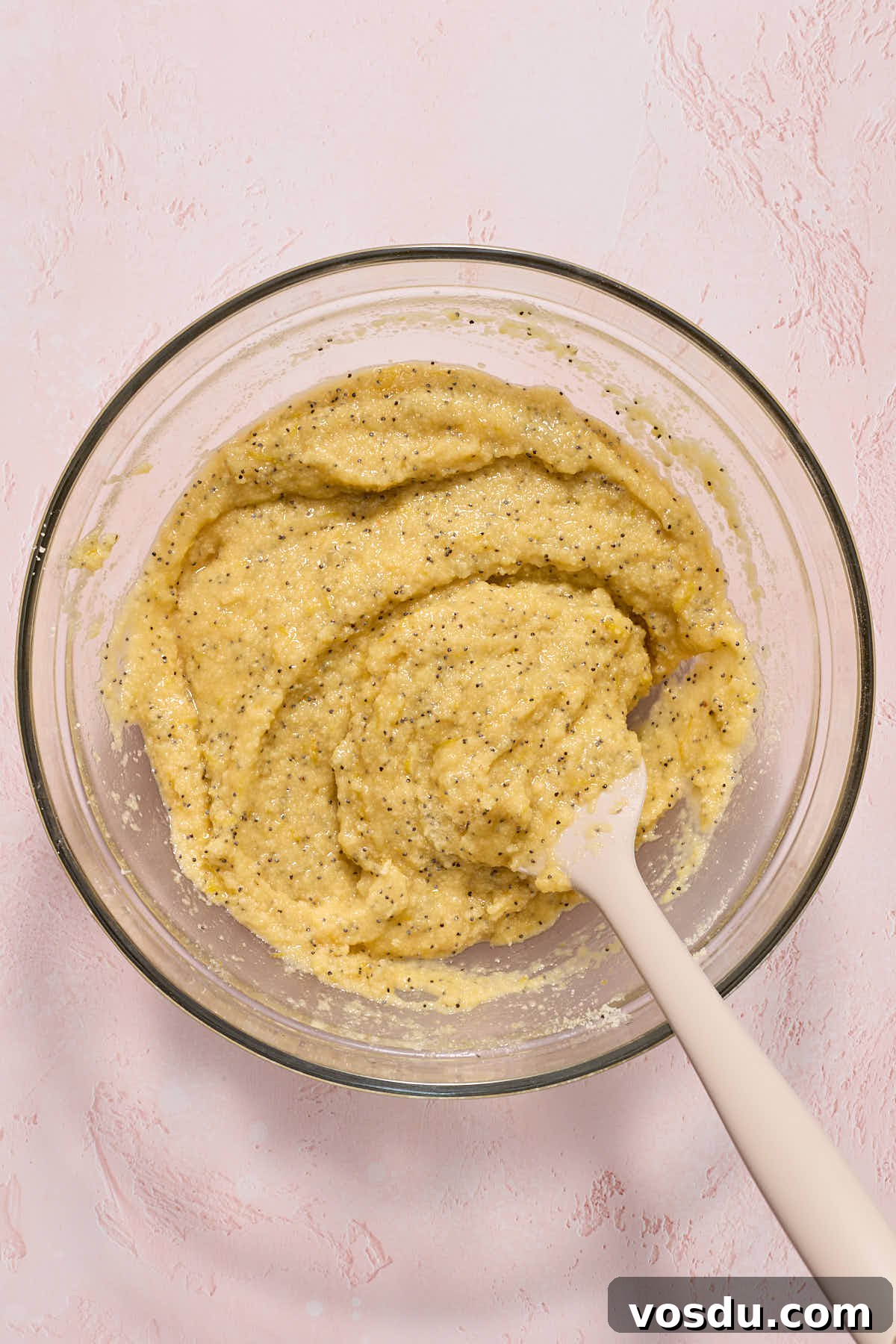 Almond Flour Lemon Poppy Seed Cake Recipe for Moist, Zesty Loaf 8 Cake batter stirred together with a spatula.