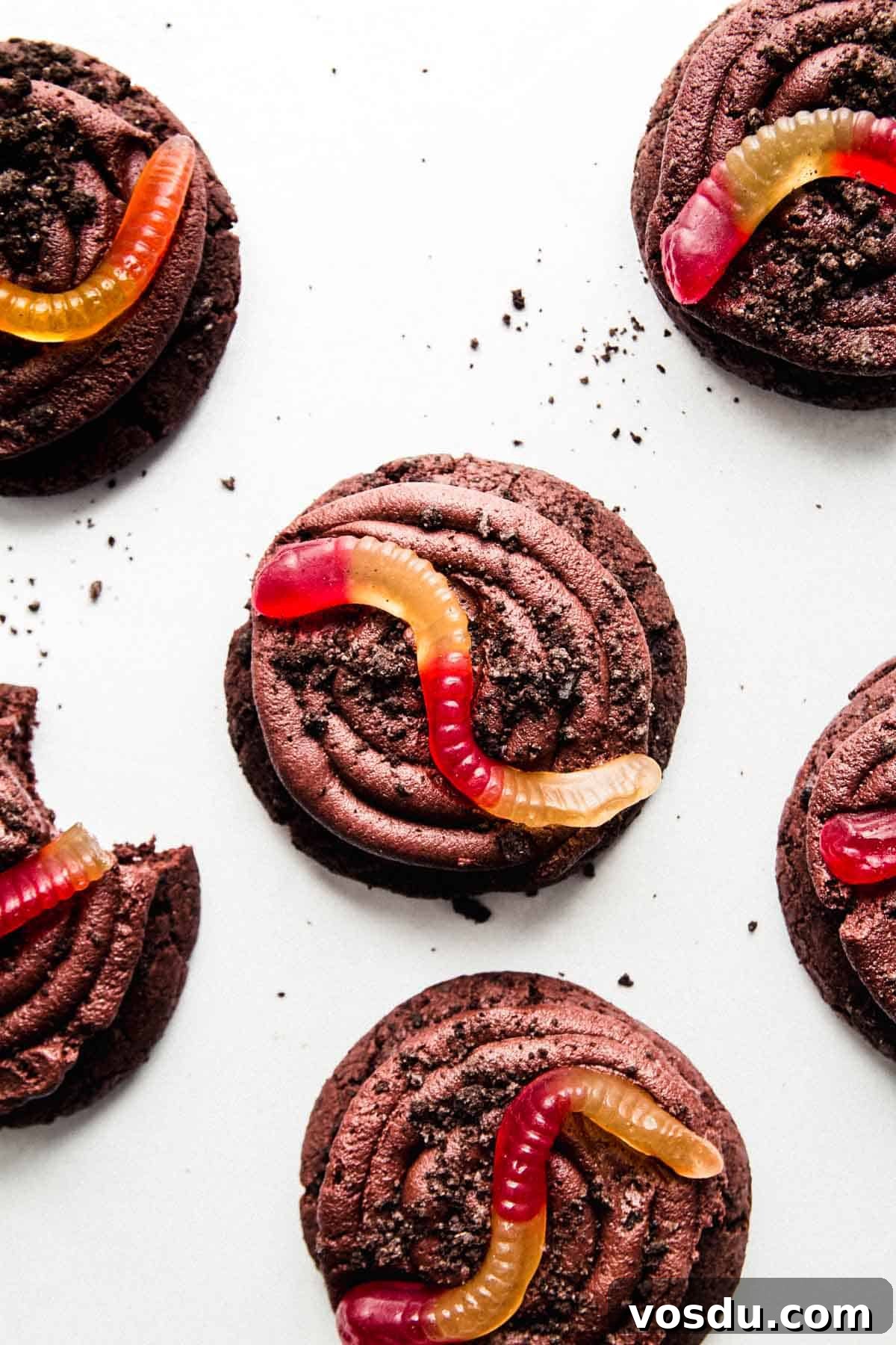 Gluten-Free Crumbl Oreo Dirt Cookies Copycat Recipe 2 Gluten-free Oreo dirt cookies topped with a swirl of chocolate frosting, Oreo crumbles, and a gummy worm.