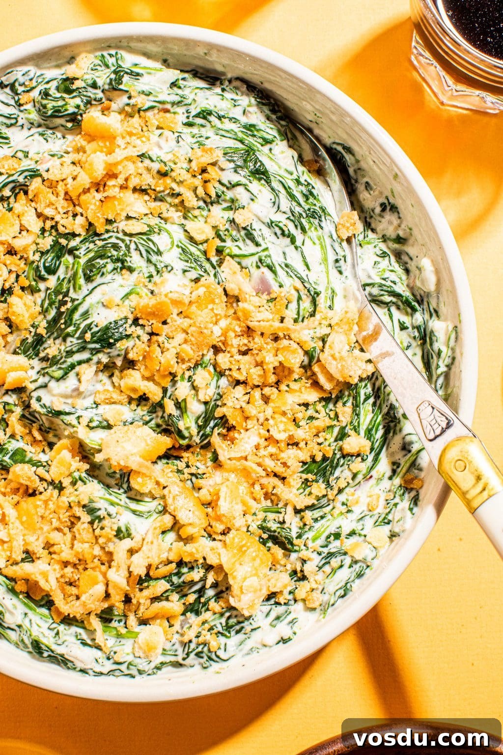 Crispy Topped Creamed Spinach with Crunchy Parmesan Crust 3 best creamed spinach with cracker topping in white bowl with spoon