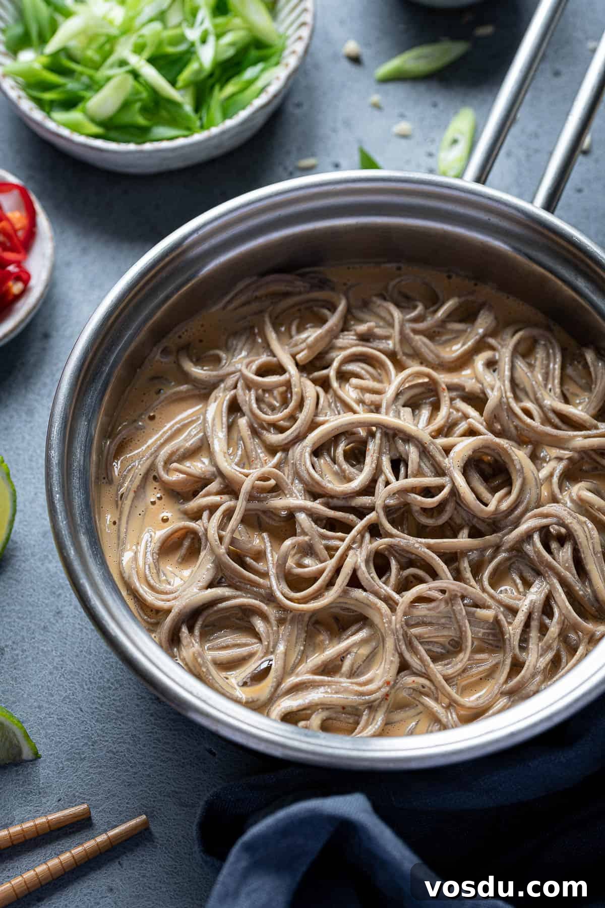 Close up of creamy peanut noodles in a pan.
