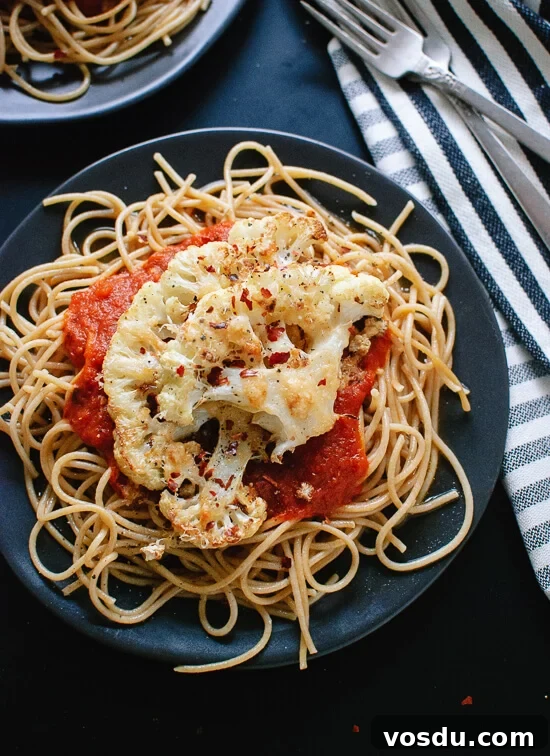 Parmesan-Crusted Cauliflower Steaks with Savory Marinara 2 Parmesan crusted, roasted cauliflower "steak" on spaghetti with marinara. This is a super simple, healthy weeknight dinner! cookieandkate.com