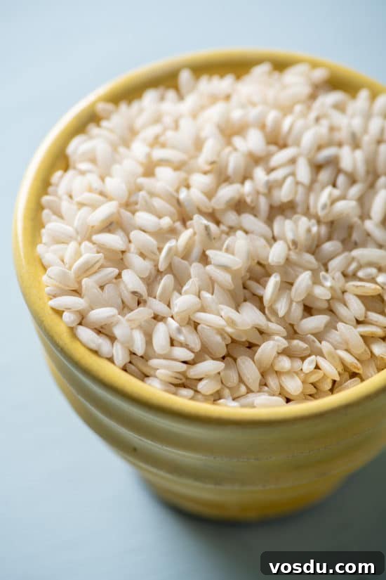 10 Essential Pantry Ingredients Every Home Cook Needs 11 Uncooked Rice in a yellow bowl.