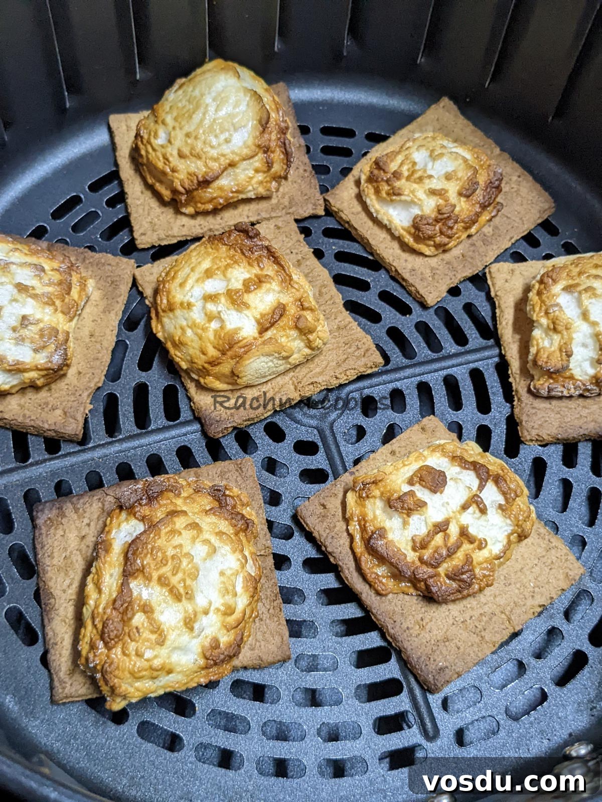 Crispy Air Fryer S'mores Recipe for Quick Desserts 7 Toasted crackers along with roasted marshmallows on top after air frying in air fryer basket.