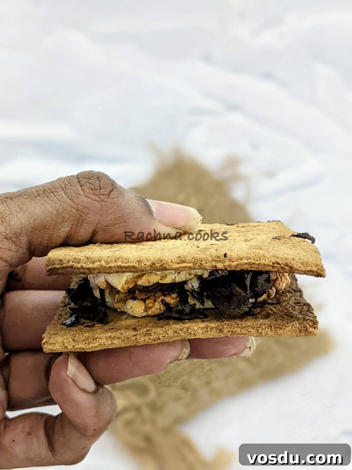 Crispy Air Fryer S'mores Recipe for Quick Desserts 8 One s'more held up in hand.