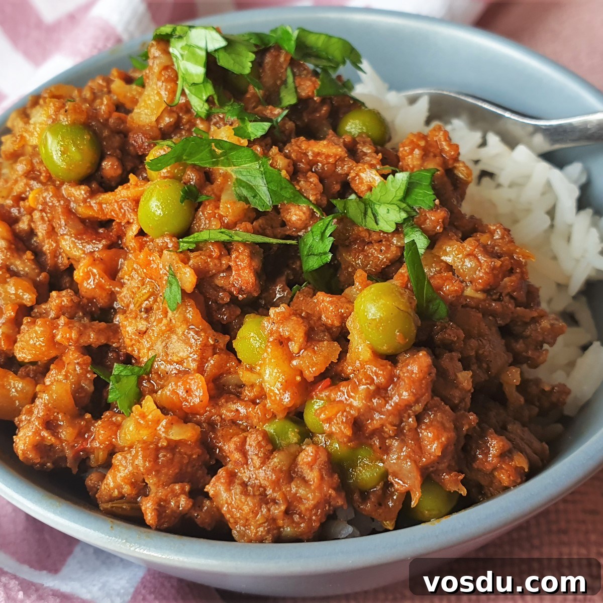 Spicy Ground Beef Curry with Fragrant Rice Recipe 2 A bowl of curry and rice sprinkled with coriander.