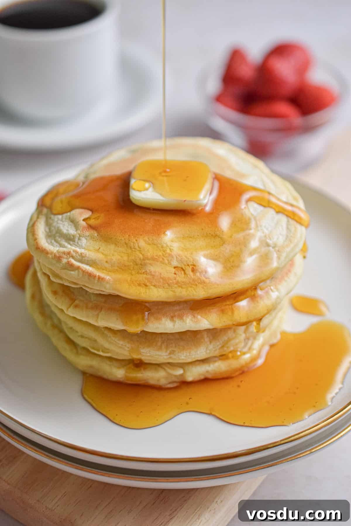 Fluffy Dairy-Free Pancakes Recipe for Breakfast and Brunch 2 Maple syrup is being drizzled over a stack of almond milk pancakes.