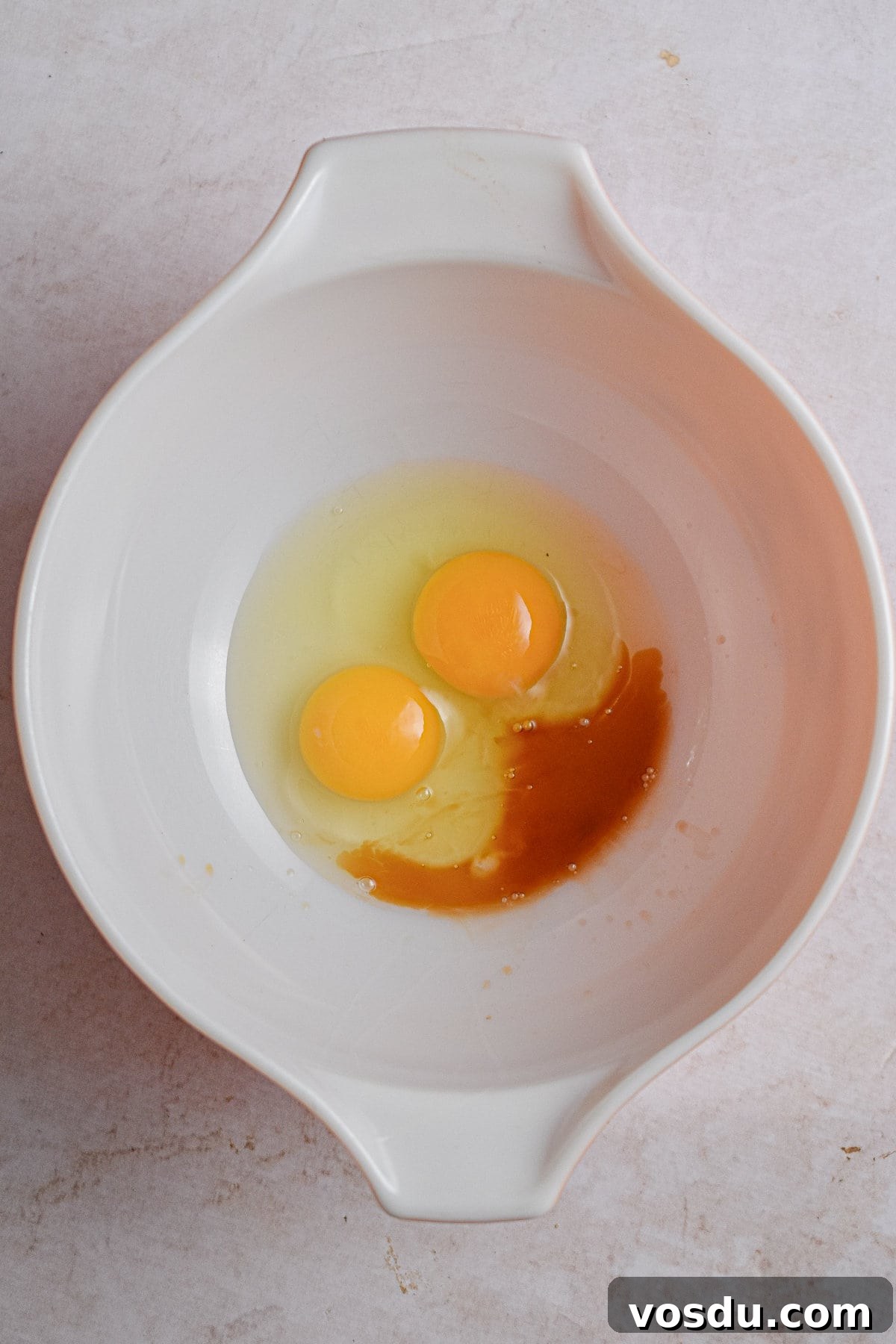 Fluffy Dairy-Free Pancakes Recipe for Breakfast and Brunch 5 The two eggs and vanilla are mixed together in a large mixing bowl.