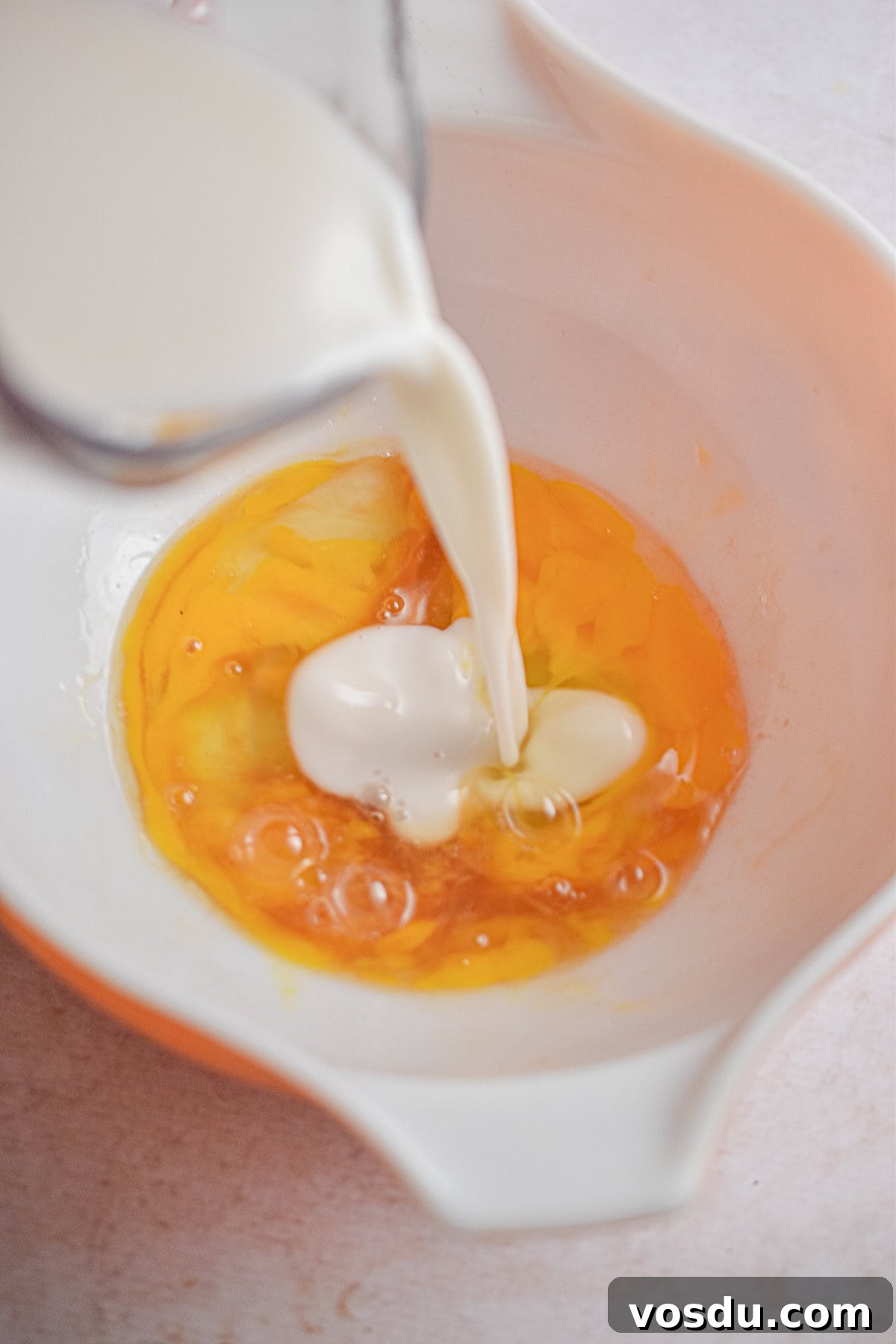 Fluffy Dairy-Free Pancakes Recipe for Breakfast and Brunch 6 The almond milk is being poured into the bowl.